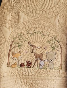 a quilted wall hanging with animals on it