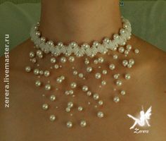 a woman wearing a white necklace with pearls on it's neck and an earring