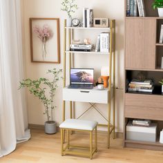 a desk with a laptop on it in front of a bookshelf