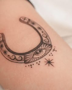 a black and white photo of a crescent tattoo