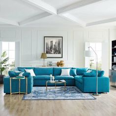 a living room with white walls and blue furniture