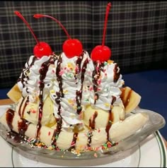 an ice cream sundae with chocolate syrup, bananas and sprinkles on top