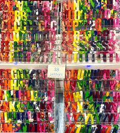 there are many letters that have been made out of colored ribbons on the wall in this store