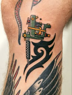 a man's leg with a tattoo on it that has an image of a machine