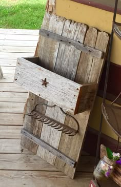 an old wooden box sitting on top of a porch next to a potted plant