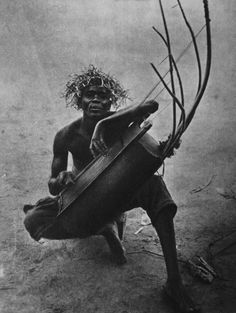 an old photo of a man playing a musical instrument