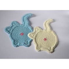 two crocheted animal coasters sitting next to each other on a white surface