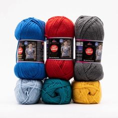 four balls of yarn in different colors on a white background with the same color for each ball