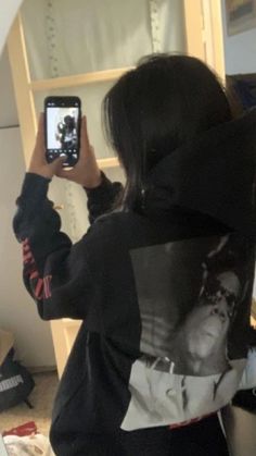 a woman taking a selfie in front of a mirror