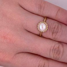 This lovely cultured pearl ring is the perfect gift for a loved one or a great self purchase. The nice size pearl has a gold beading design that is very simple but elegant. The pearl is the most desirable color with a nice white color with rose hues. This ring is a size 6.5 but is sizable. Just let our shop know what size your need and our in house jeweler can take care of that. The details for this beautiful ring are listed below:Metal Quality: 14 K Yellow Gold Gemstone: Freshwater Pearl Gemsto Luxury Everyday Yellow Gold Pearl Ring, Wedding Pearl Open Ring, Open Pearl Ring For Wedding, Pearl Open Ring For Wedding, Pearl Rings With Pearl Chain For Gift, Pearl Ring With Pearl Chain As A Gift, White Pearl Ring With Pearl Chain, Gift Pearl Ring With Pearl Chain Detail, Pearl Chain Ring Perfect As A Gift