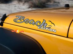 a yellow vehicle with the word beach written on it