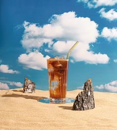 a drink in a tall glass on the sand