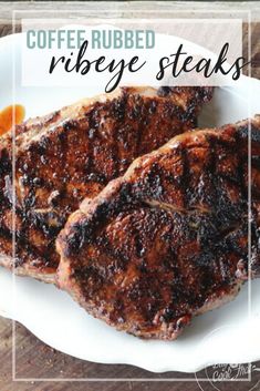 two steaks on a white plate with coffee rubed ribeye steaks in the background