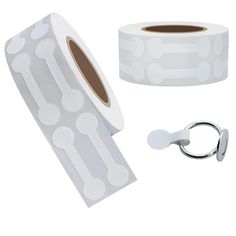 two rolls of white polka dot tape next to a pair of scissors and a keychain