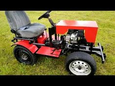 a red lawn mower sitting in the grass