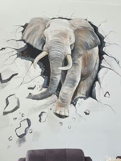 an elephant breaking through the wall with its trunk and tusks, in a living room