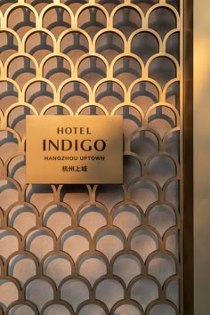 the hotel indigoo sign is posted on the door to the room's entrance