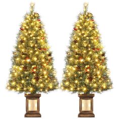 two artificial christmas trees with lights on them