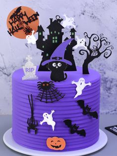 a purple cake decorated with halloween decorations