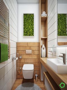 a bathroom with a toilet, sink and green plants on the wall