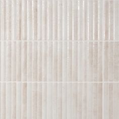 a white tile wall with vertical lines on it