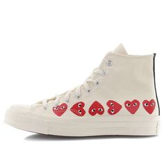 The iconic Chuck Taylor silhouette gets a luxurious upgrade with the Comme des Garcons Play x Chuck 70 Hi Top Multi Heart. This high top sneaker features a premium canvas upper in an off white hue, with shiny metal eyelets, double stitching, and Comme des Garcons heart icons on the sidewall for a signature touch. A vulcanized rubber midsole and rubber outsole complete the vintage look and feel of this must-have sneaker. Chuck Taylor Outfit, Heart Converse, White Converse With Dress, Converse With Dress, Cdg Converse, Converse Play, Converse Comme Des Garcons, Play Converse, Garcons Converse