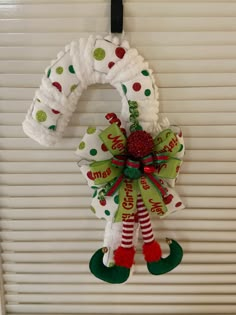 a christmas wreath hanging from the side of a garage door