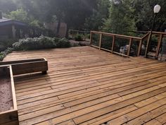 a wooden deck surrounded by trees and bushes