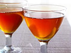 two glasses filled with liquid sitting on top of a table