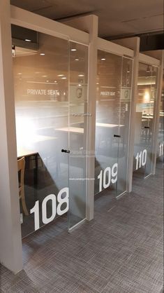 an empty room with glass doors that say private seat and 1080 on the wall