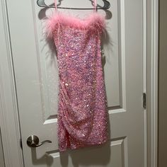 Windsor Strapless Pink Sequin Party Dress With Feather Top, Brand New With Tags/Never Worn Party Dress With Feather Trim And Spaghetti Straps, Spaghetti Strap Dress With Feather Trim For Party, Fitted Strapless Dress With Feathers, Glamorous Strapless Dress For Costume Party, Sleeveless Mini Dress With Feather Trim For Prom, Glamorous Strapless Mini Dress For Costume Party, Strapless Dresses With Feather Trim For Party Season, Fitted Strapless Dress With Feather Trim For Parties, Feather Detailed Mini Dress For Prom Season