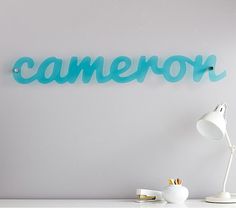 a white desk topped with a lamp next to a sign that says camera on it