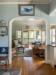 a living room with blue walls and wooden floors