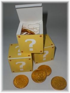 some gold coins are in a box with question marks on them