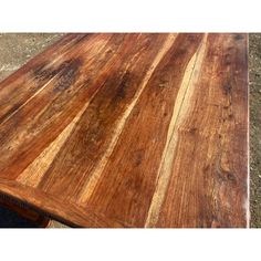 a wooden table that is sitting on the ground