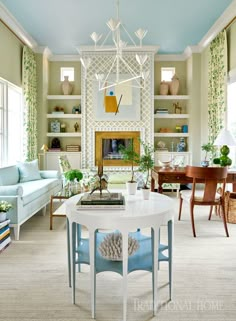 a living room filled with lots of furniture and decor on top of white shelves next to a fire place