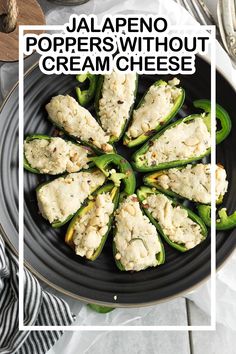 jalapeno poppers without cream cheese on a black plate with spoons