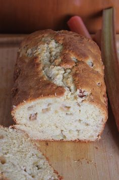 a loaf of bread sitting on top of a wooden cutting board