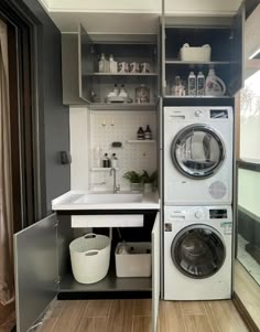 a washer and dryer in a small room with open shelving on the wall