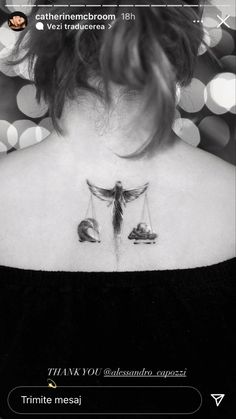 the back of a woman's neck with two scales on it