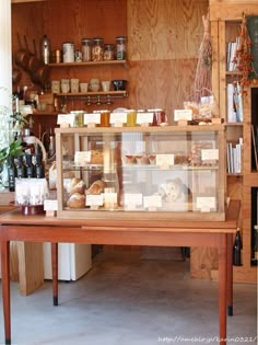 a wooden table topped with lots of shelves filled with food