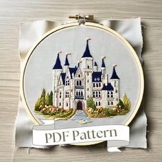 an embroidery pattern with a castle in the middle and a ribbon around it that says, pdf pattern