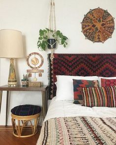 a bedroom with a bed, lamp and rug on the floor