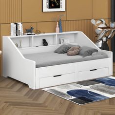 a white bed sitting on top of a wooden floor