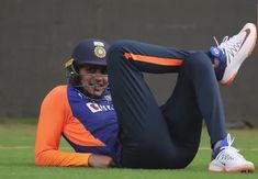 a man laying on the ground with his leg up in front of him wearing a helmet