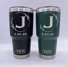 two yeti tumblers sitting next to each other on a white surface with the letter j in it