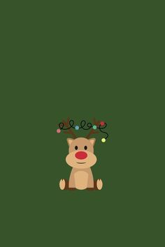 a reindeer sitting on top of a green wall