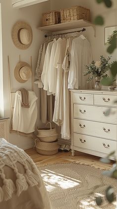 a bedroom with white furniture and baskets on the wall