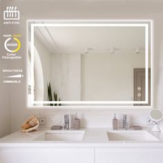 a bathroom with a large mirror above the sink and two sinks below it in front of a white wall