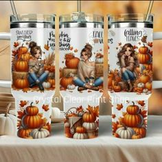 four coffee mugs sitting on top of a table covered in pumpkins and leaves